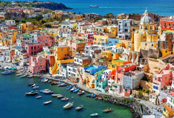 The town of Procida is packed with colourful houses that reaches all the way to the very edge of the sea.